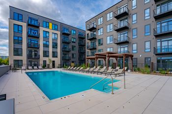 Expansive pool deck w/ sun loungers